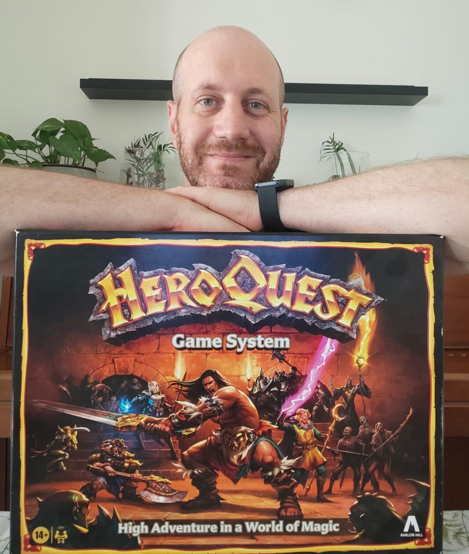 Eli from Blue Dragon Board Games holding the HeroQuest base game