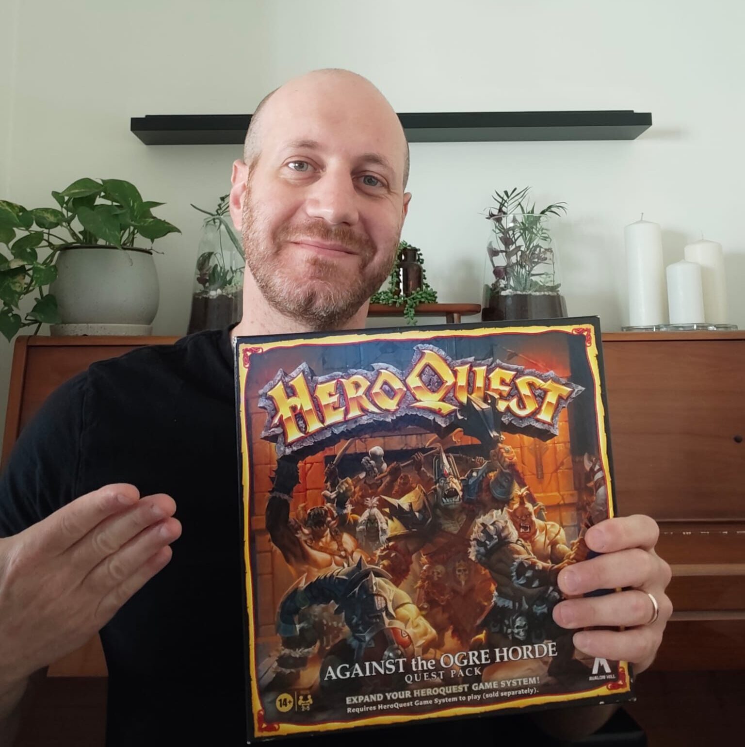 Eli from Blue Dragon Board Games holding his own copy of HeroQuest Against the Ogre Horde
