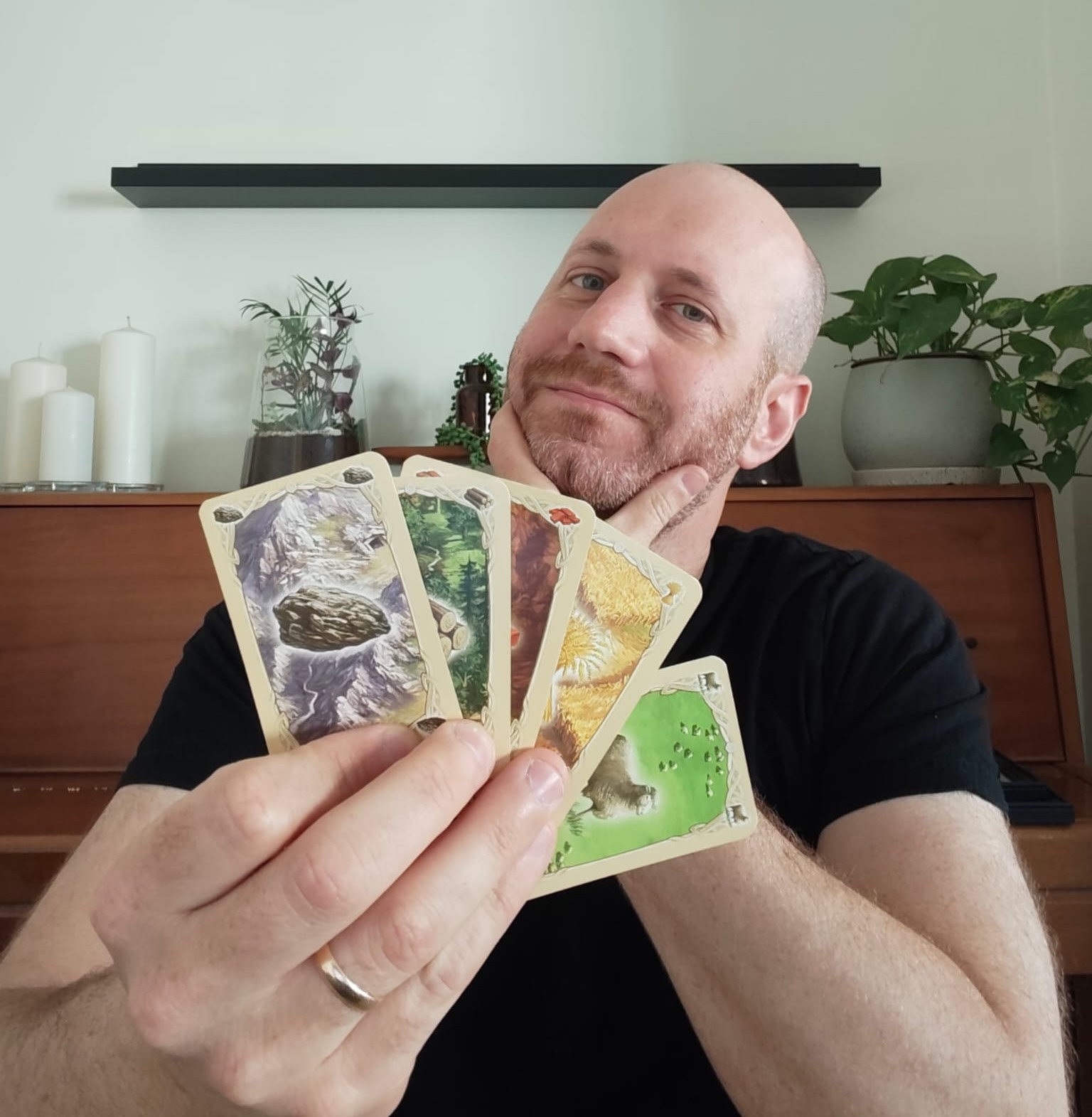 Eli from Blue Dragon Board Games holding his own copy of Catan