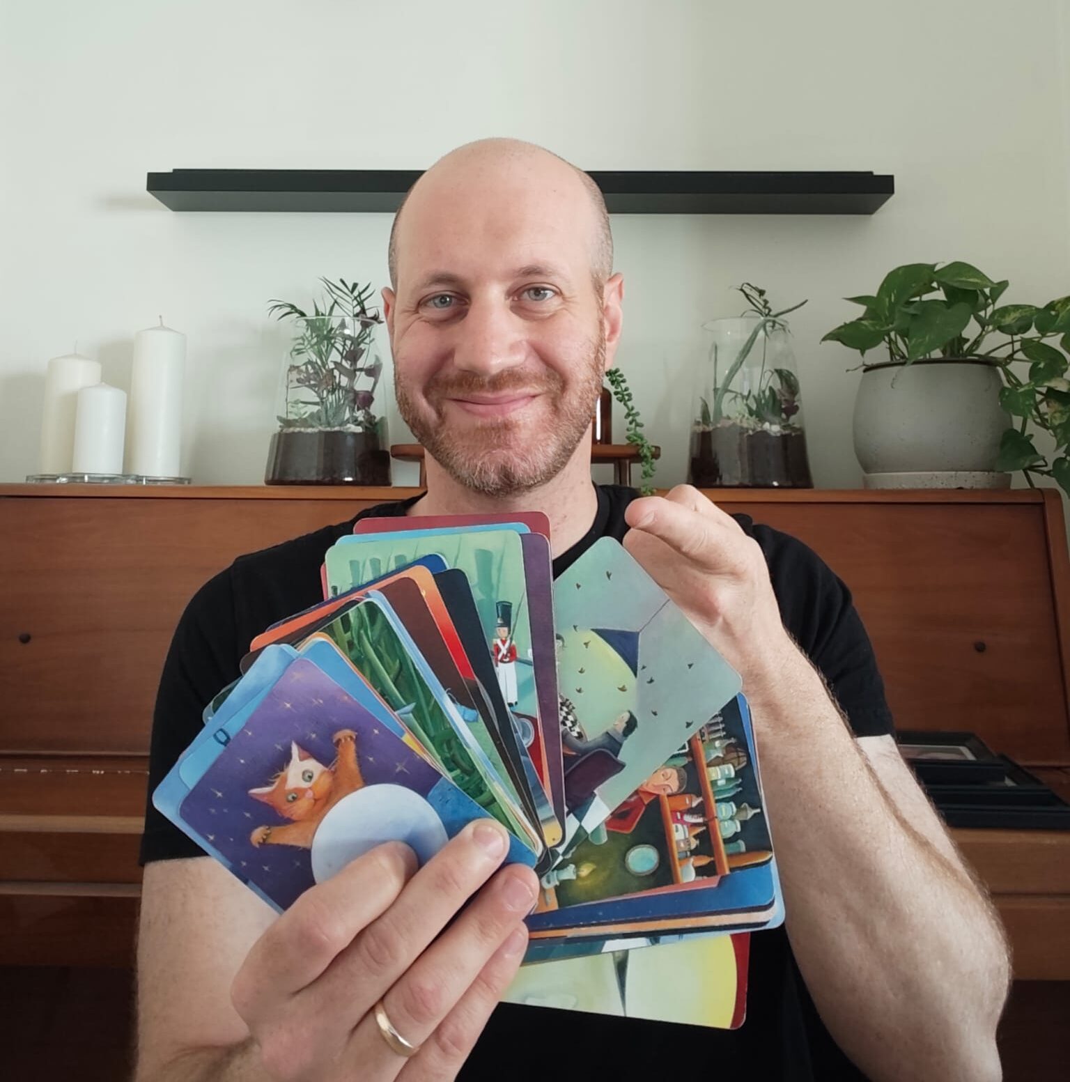 Eli from Blue Dragon Board Games holding his own copy of Dixit